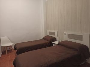 En eller flere senge i et værelse på Vivienda Planta Baja + 3 billeder