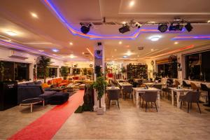 a restaurant with tables and chairs and lights at Cherry Signature Condos in Adentan