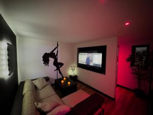 a living room with a couch and a dancer on the wall at L' Instant Se Crée in Oignies