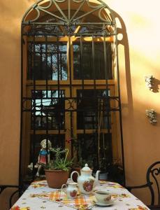 a table with a teapot and a tea pot on it at Anthea Butik Otel in Adalar