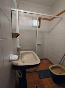 a bathroom with a sink and a toilet at Hotel Portal Norte Neuquino in Chos Malal