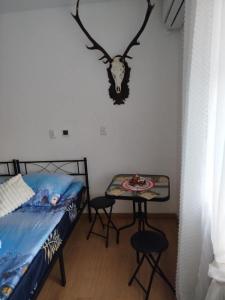 a bedroom with a bed and a table with two stools at Hunter u Seby in Jugów +1 photo