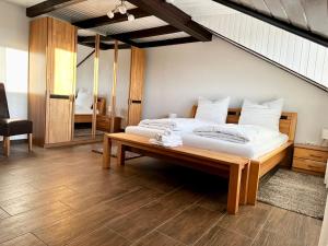 a bedroom with a large bed and a table at LUMI Living in Schlüsselfeld
