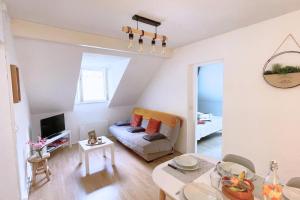 a living room with a couch and a table at Gîte cosy et paisible près de La Mongie in Campan