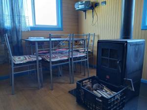 una camera con piano cottura, tavolo e sedie di Cabaña de campo, Puacura - Castro a Putemún
