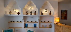 a room with shelves filled with vases and lights at Hôtel Riad La Nouvelle Etoile - Agadir in Agadir