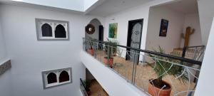a hallway with a stairway with a potted plant at Hôtel Riad La Nouvelle Etoile - Agadir in Agadir