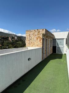 a balcony of a house with green grass at Luxury apartment with pool view and Jacuzzi in Cali