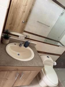 a bathroom with a sink and a toilet at Luxury apartment with pool view and Jacuzzi in Cali