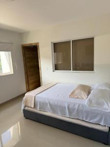 a bedroom with a large bed with a window at Luxury apartment with pool view and Jacuzzi in Cali +11 photos