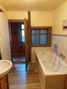 a bathroom with a bath tub and a sink at Ferienwohnung Harald in Gotha