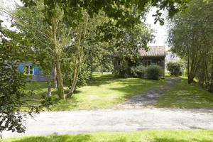 a house with a yard with trees and a driveway at ZEcamping 3 étoiles animaux acceptés piscine snack bar et restaurant in Moutiers-sous-Chantemerle