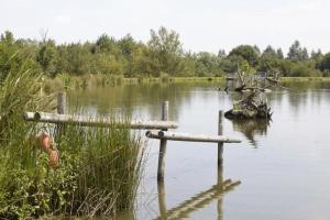 a body of water with two wooden posts in it at ZEcamping 3 étoiles animaux acceptés piscine snack bar et restaurant in Moutiers-sous-Chantemerle +13 photos