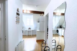 a kitchen and dining room with a mirror at Gîte cosy et paisible près de La Mongie in Campan