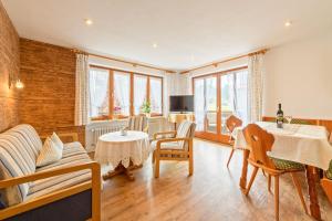 a living room with a table and chairs at Haus Aigner in Fischen