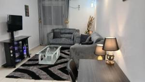 a living room with a couch and a table at At your home in Conakry in Conakry