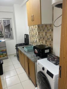 a kitchen with a counter with a washer and dryer at At your home in Conakry in Conakry +22 photos