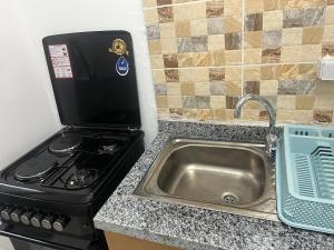 a kitchen with a stove and a sink at At your home in Conakry in Conakry