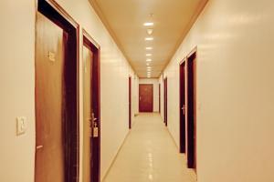 a corridor of an office building with a long hallway at Collection O One Hotel in Ghaziabad