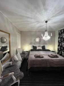 een slaapkamer met een groot bed en een kroonluchter bij Apartment Northernlightroad in Rovaniemi