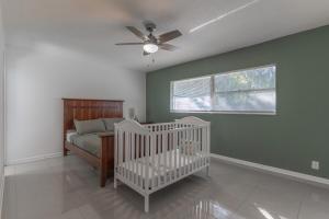 een slaapkamer met een wieg en een plafondventilator bij Legoland Escape in Winter Haven +30 foto's