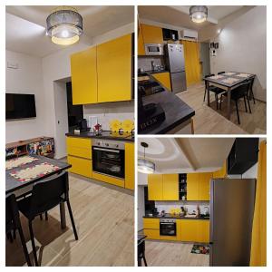 a kitchen with yellow cabinets and a table in it at Appartamento alla Immacolata Noto Centro Storico in Noto
