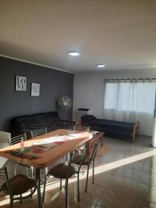 a living room with a table and a couch at Departamentos Necochea in Necochea