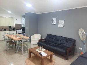 a living room with a couch and a table at Departamentos Necochea in Necochea