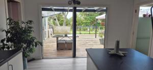 a kitchen with a door open to a patio at Hidden gem cheap and affordable in Te Kopuru