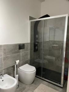 a bathroom with a shower and a toilet and a sink at ROCKEFELLER SUIT Apartment in Sassari