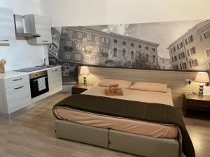 a bedroom with a large bed with a teddy bear on it at ROCKEFELLER SUIT Apartment in Sassari
