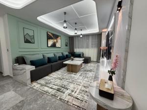 a living room with a couch and a table at Hilton View Tower Residency Apartment Tanger Partial Sea View in Tangier