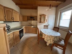 a kitchen with a table and a table and chairs at Ferienhaus Heideblick Gräfenhainichen in Gräfenhainichen
