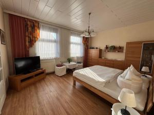 a bedroom with a bed and a flat screen tv at Ferienhaus Heideblick Gräfenhainichen in Gräfenhainichen