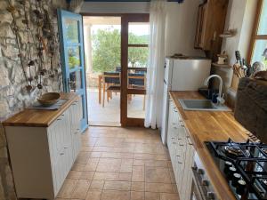 a kitchen with a sink and a counter top at Girica in Ugrinići +20 photos