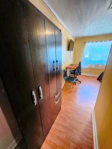an office with a large wooden cabinet and a desk at Hostel Notro Valdivia in Valdivia