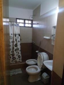 a bathroom with a toilet and a sink at Cabañas Soledad in Potrerillos +23 photos