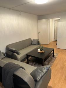 a living room with a couch and a table at Modern Oslo Studio Near Aker Brygge in Oslo +1 photo