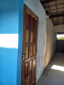 een open deur in een kamer met een blauwe muur bij kitinet IMMANU'EL Moreré-Ba in Cayru