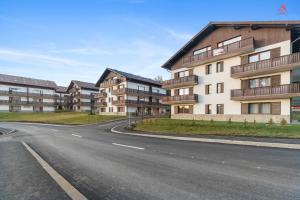 an empty street in front of apartment buildings at Apartament 1 C4 Grand Chalet Poiana Brasov in Braşov
