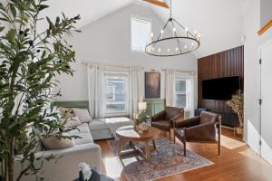 a living room with a couch and a table at Duplex Rooftop at MIT Kendall Sq - 2 FREE Parking in Cambridge