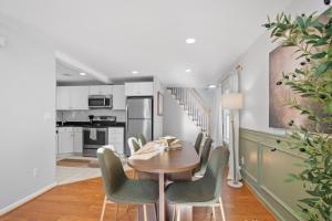 a kitchen and dining room with a table and chairs at Duplex Rooftop at MIT Kendall Sq - 2 FREE Parking in Cambridge