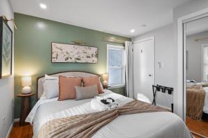 a bedroom with a bed with a cat sitting on it at Duplex Rooftop at MIT Kendall Sq - 2 FREE Parking in Cambridge