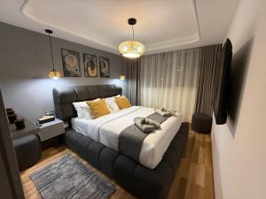 a bedroom with a large bed with a black headboard at Hilton View Tower Residency Apartment Tanger Partial Sea View in Tangier