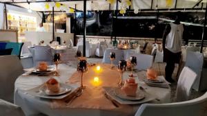 a table with plates of food on it in a restaurant at COMPLEXE L OCEANE Hotel in Kribi