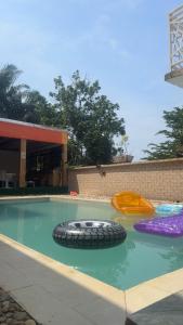 a swimming pool with two inflatable tires in the water at COMPLEXE L OCEANE Hotel in Kribi