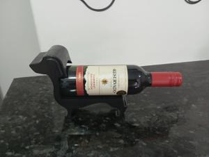 a bottle of wine sitting on top of a table at UniversiFlat in Ponta Grossa