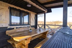 a wooden table on the porch of a cabin at Ustronne Karkonosze in Miłków