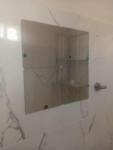 a mirror on a wall in a bathroom at Casa alexander in Acapulco