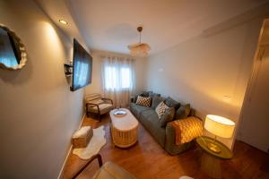 a living room with a couch and a table at L'écrin du sancy in La Bourboule